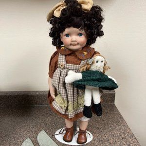 Porcelain doll holding a baby doll